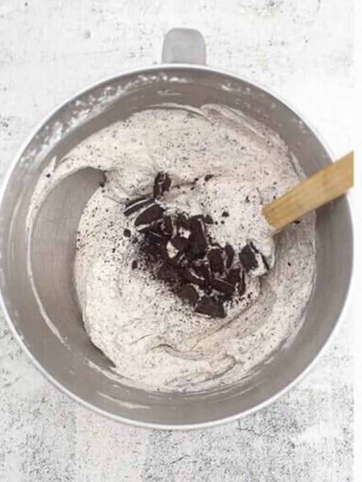 Folding chopped cookie chunks into the no churn ice cream base.