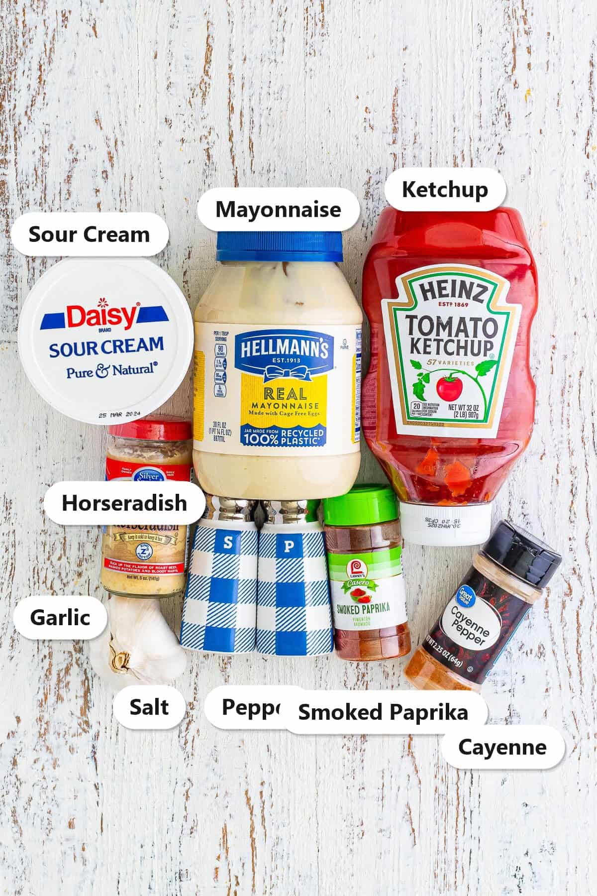 Labeled ingredients to make Copycat Outback Bloomin Onion Sauce including mayonnaise, sour cream, ketchup, horseradish, garlic, and spices.