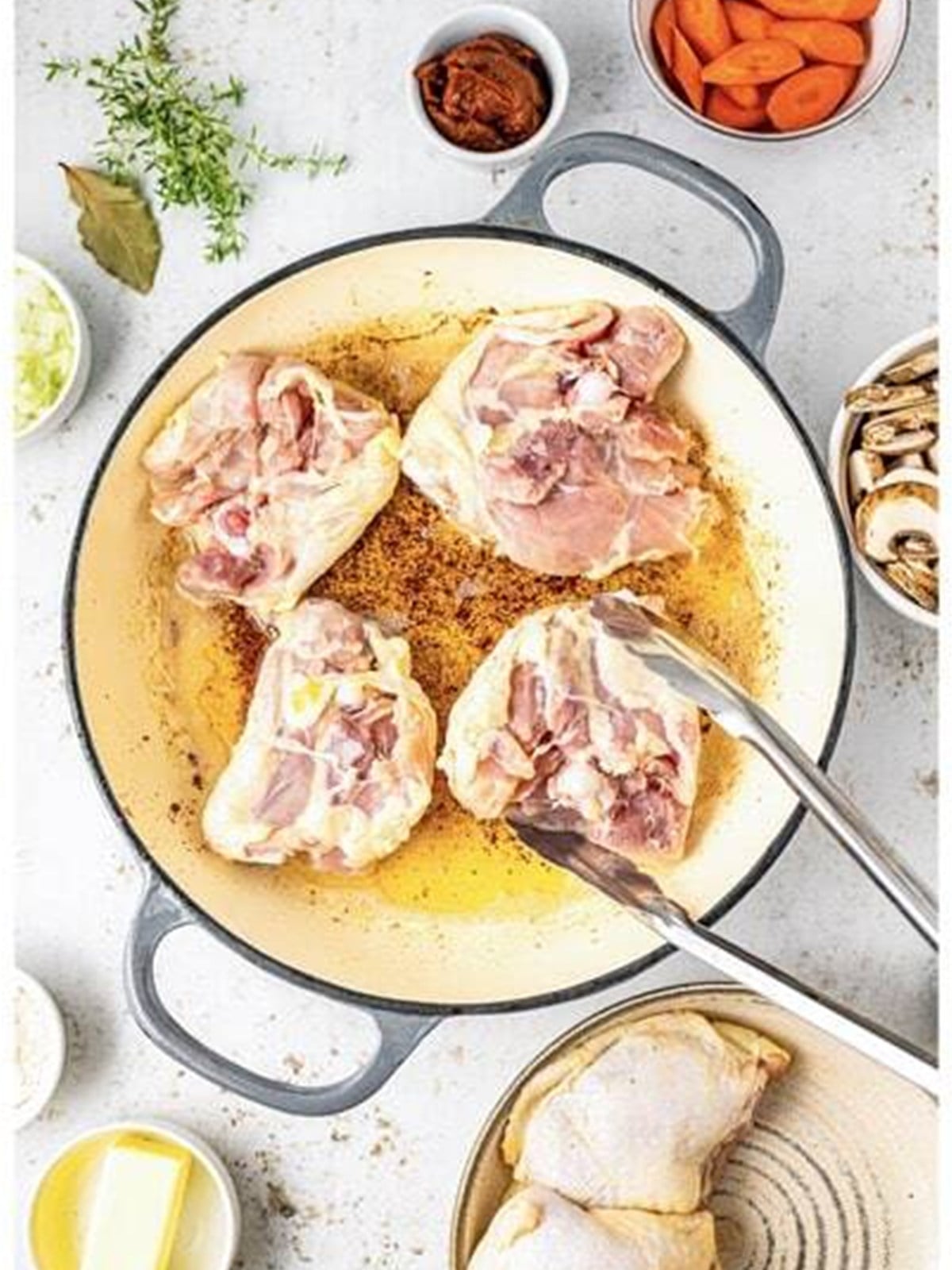 Bone-in chicken thighs browning skin side down in bacon drippings for coq au vin.