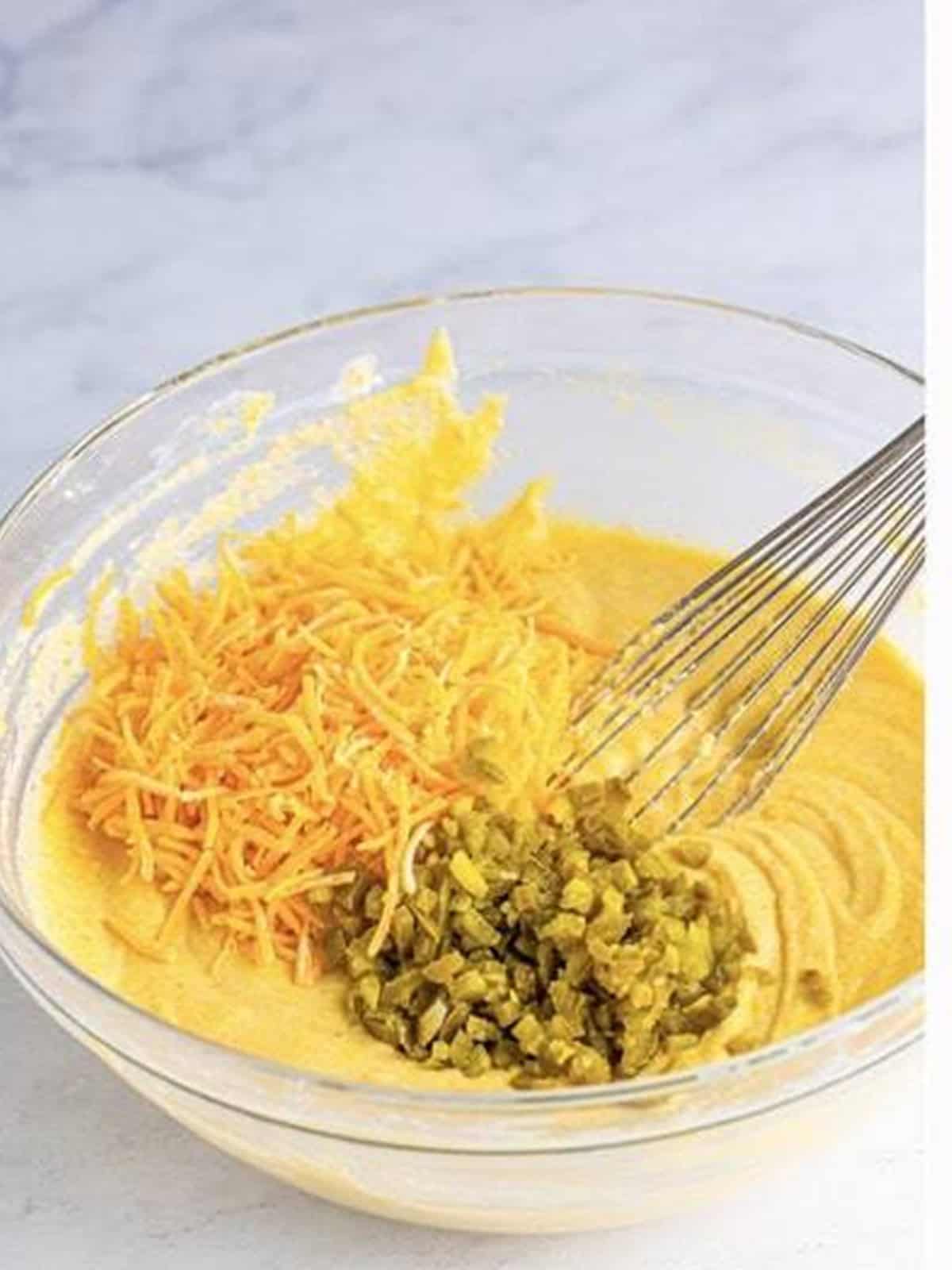 Shredded cheddar and chopped jalapenos added to corn dog batter.