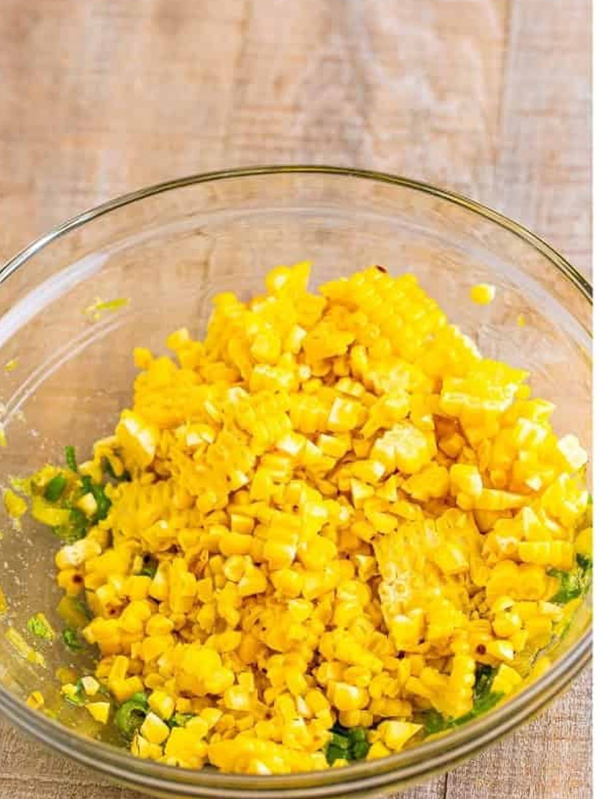 Charred corn kernels cut off the cob and added to the bowl of seasonings.