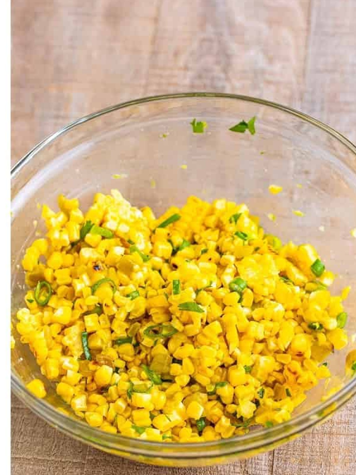 The finished grilled corn salsa stirred together in a glass bowl.
