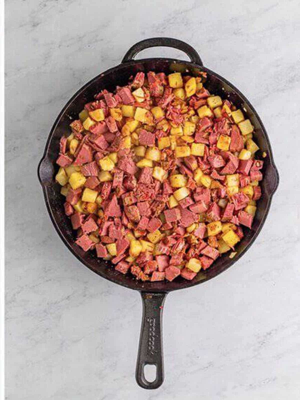 Corned beef hash flipped to show the golden brown crispy crust.