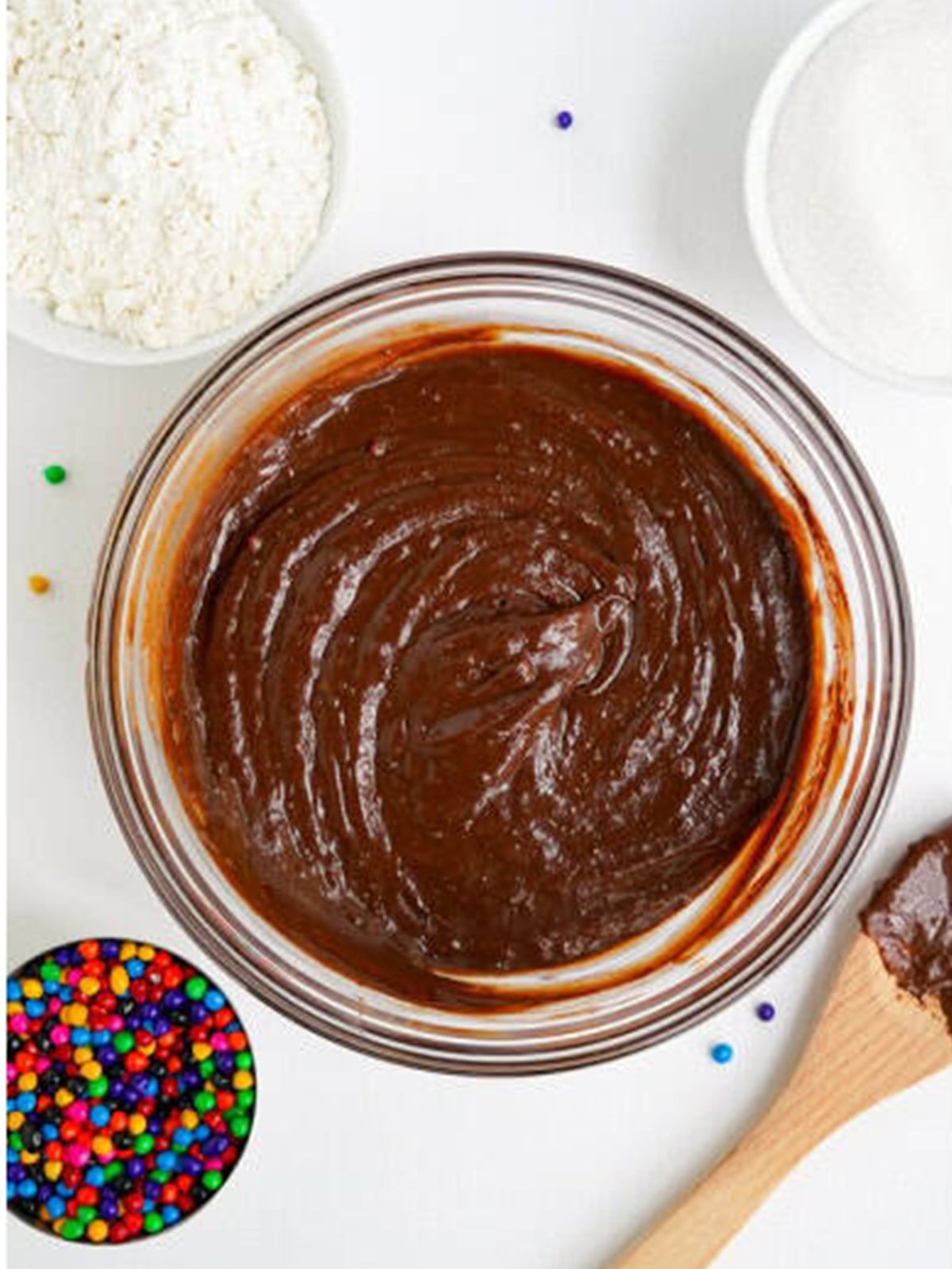 Cosmic brownie batter mixed until smooth and glossy in a glass bowl.