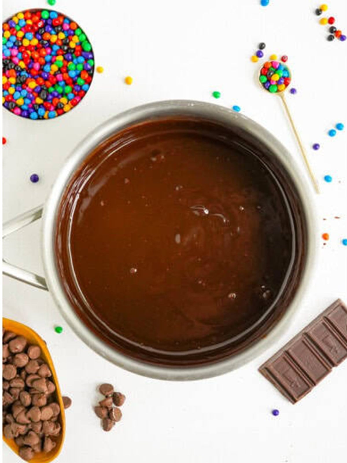Chocolate ganache for cosmic brownies stirred smooth in a bowl.