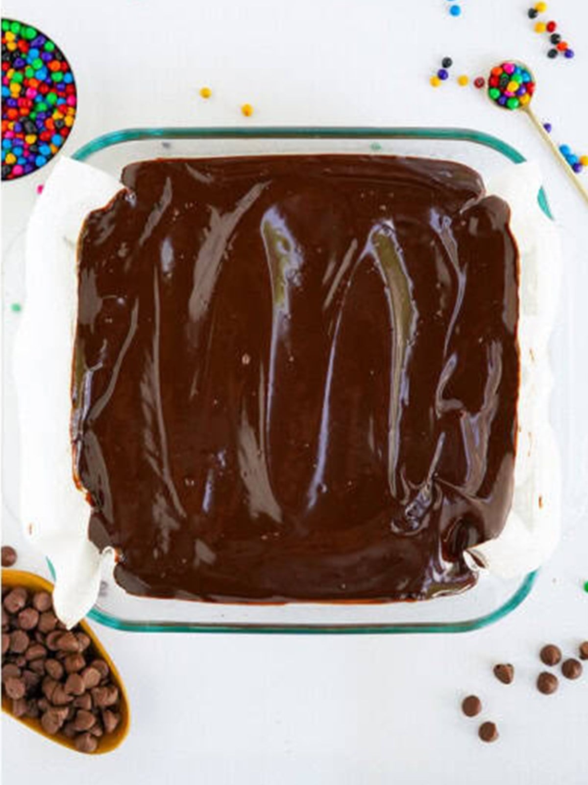 Chocolate ganache spread evenly over the cooled cosmic brownie base.
