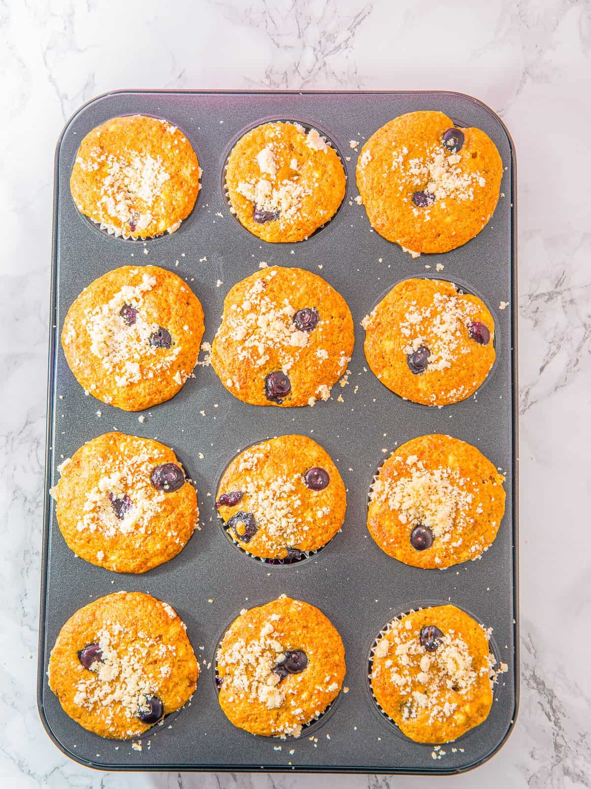 Golden baked Cottage Cheese Blueberry Muffins in the tin.