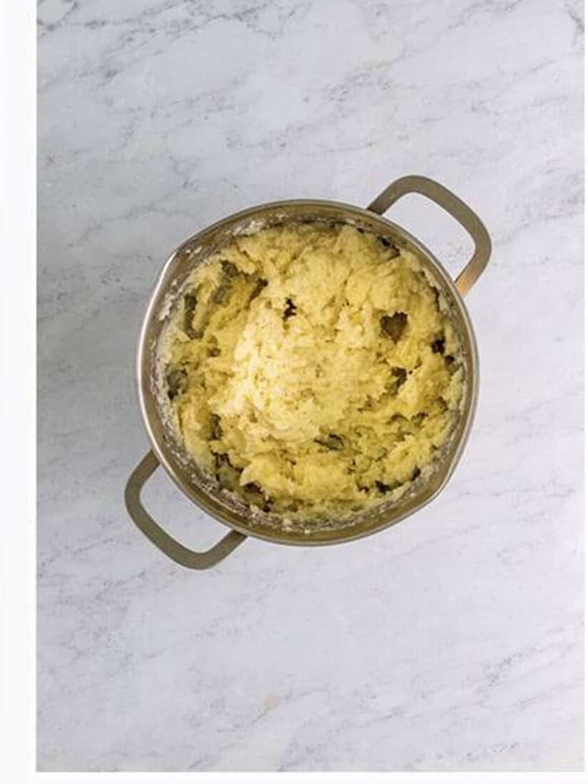 Creamy parmesan mashed potatoes in a pot for the cottage pie topping.