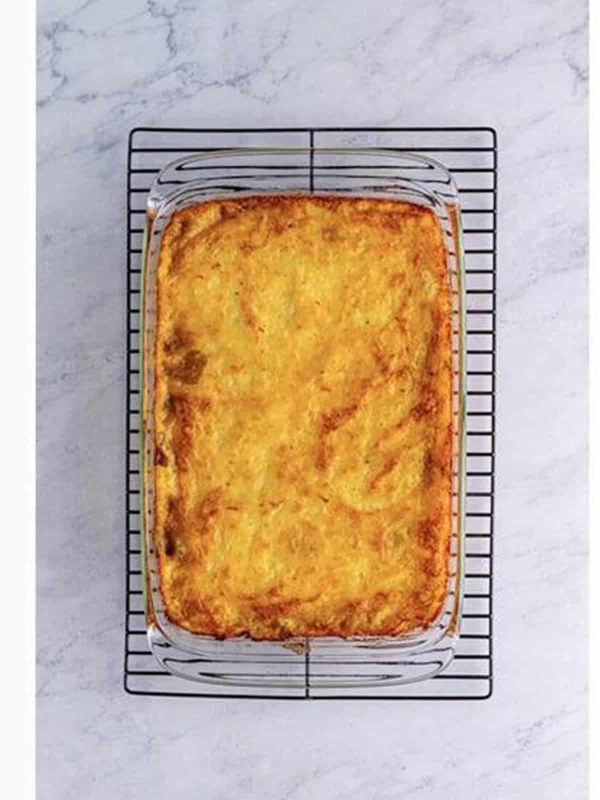 A golden baked cottage pie with a crisp parmesan mashed potato top.