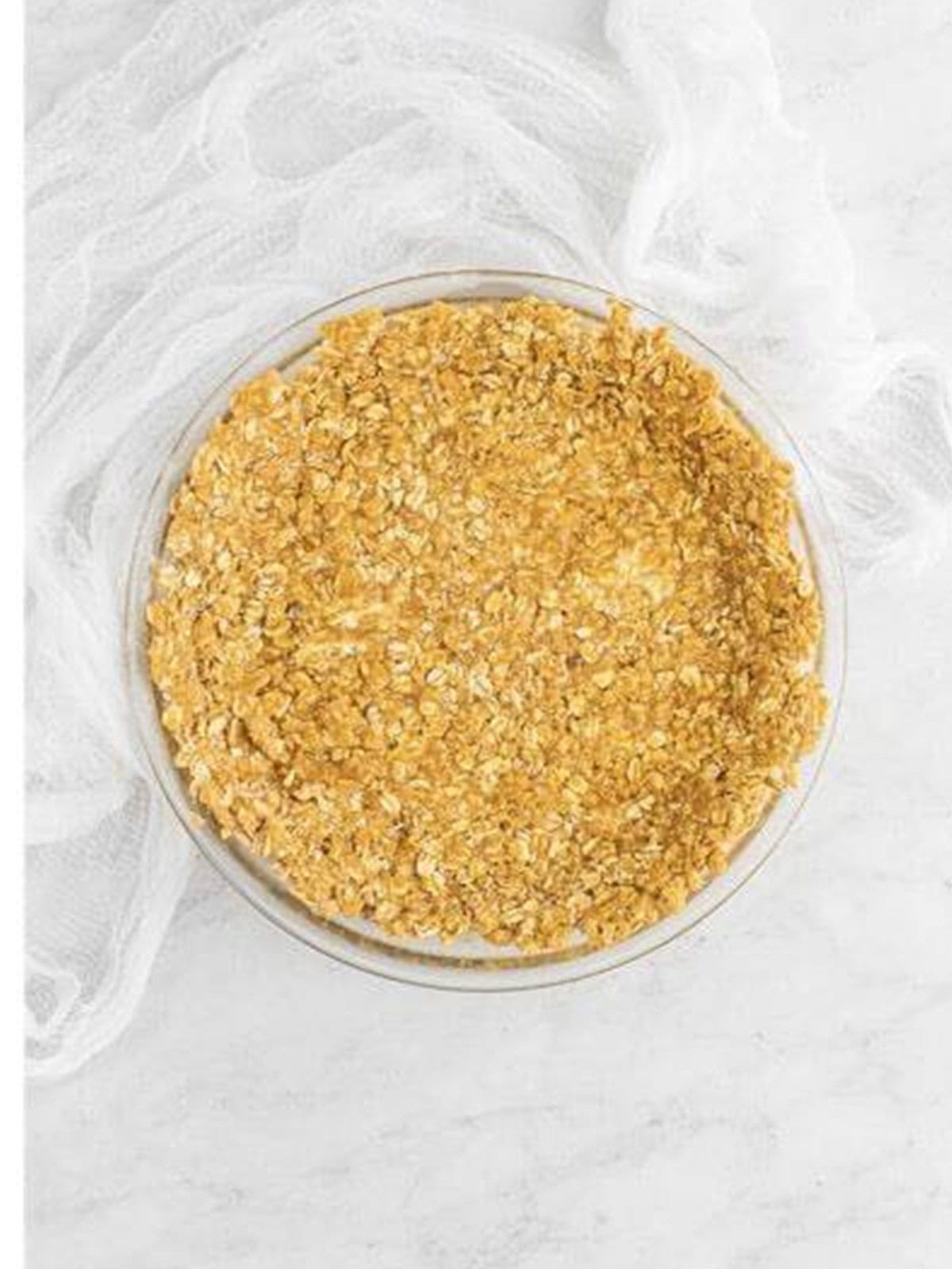 Oat cookie crust pressed into a glass pie dish.