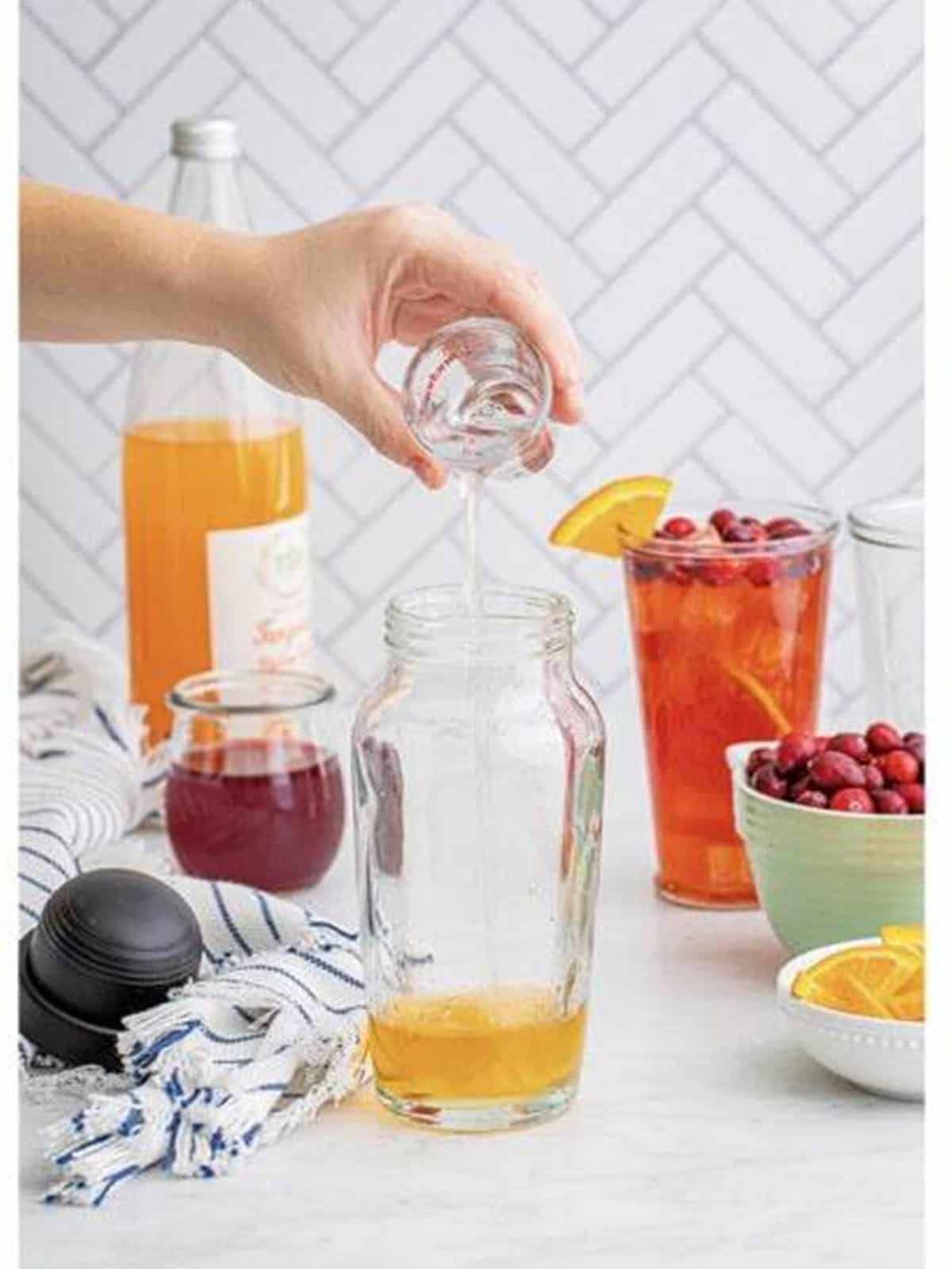 Cranberry juice added to the cocktail shaker.