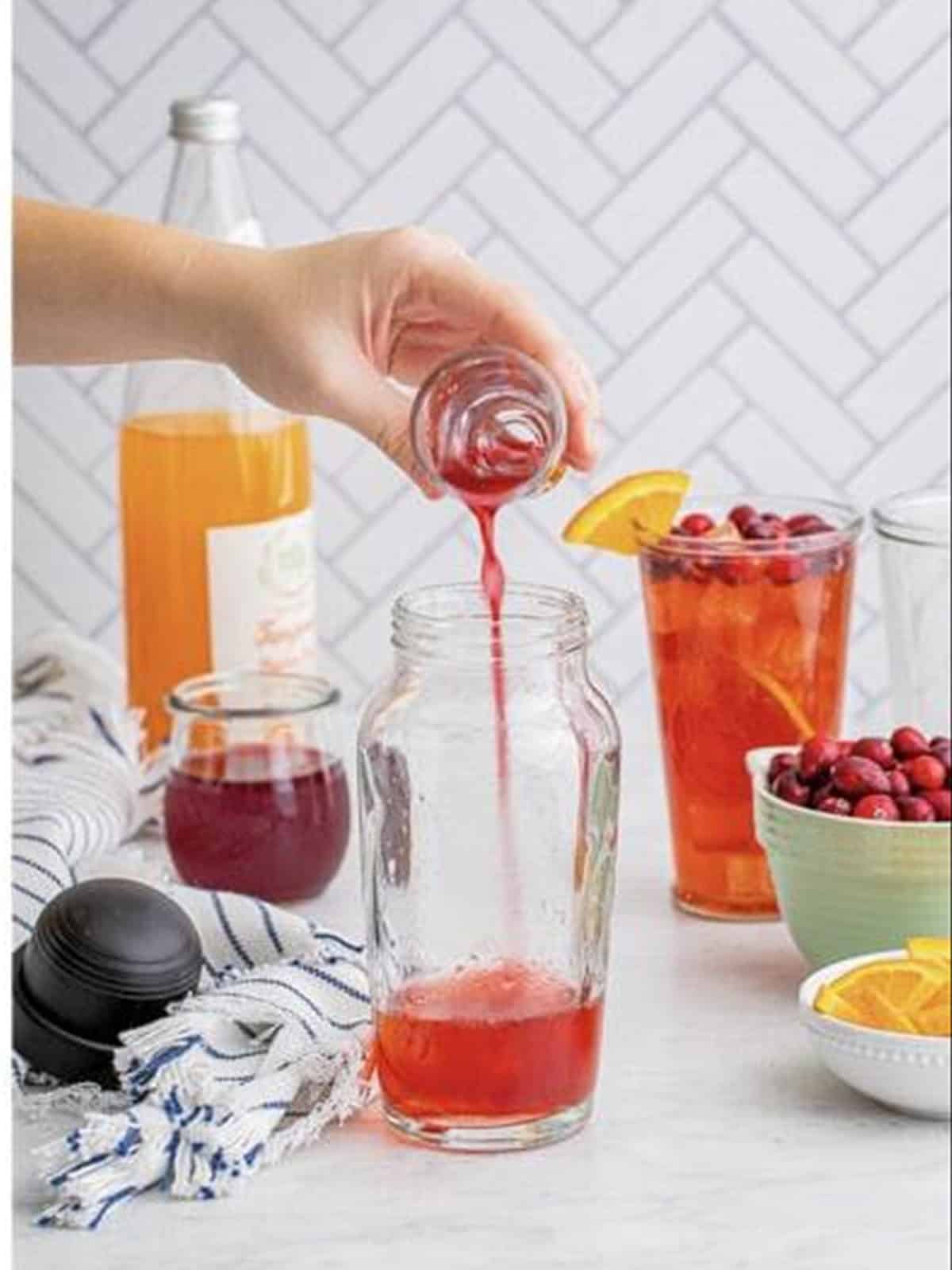 Triple sec poured into the shaker with the rum and cranberry juice.