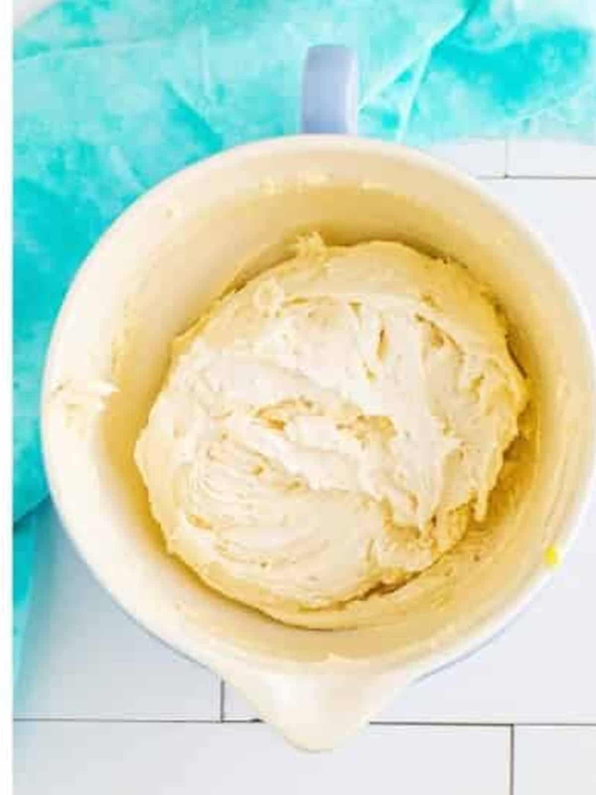 Soft cream cheese cookie dough mixed together in a bowl after adding egg, vanilla, and flour.