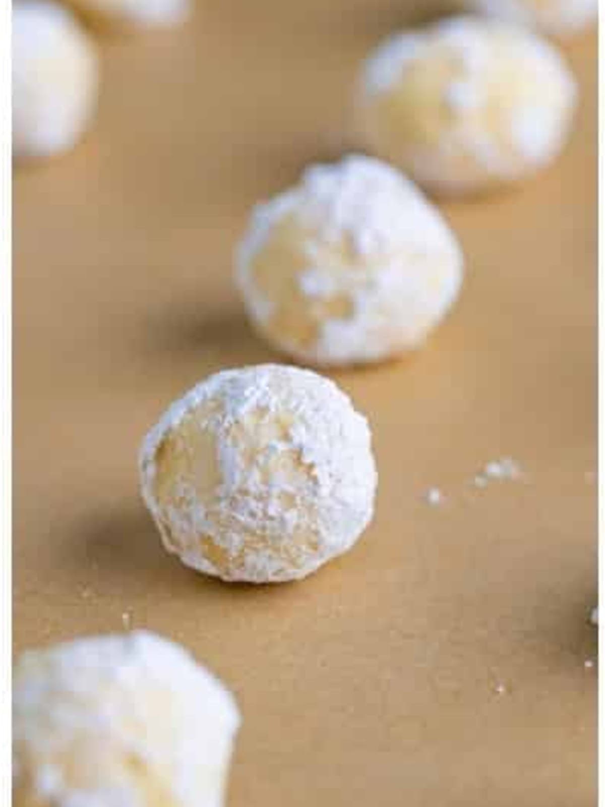 Chilled cream cheese cookie dough balls rolled in powdered sugar to coat.