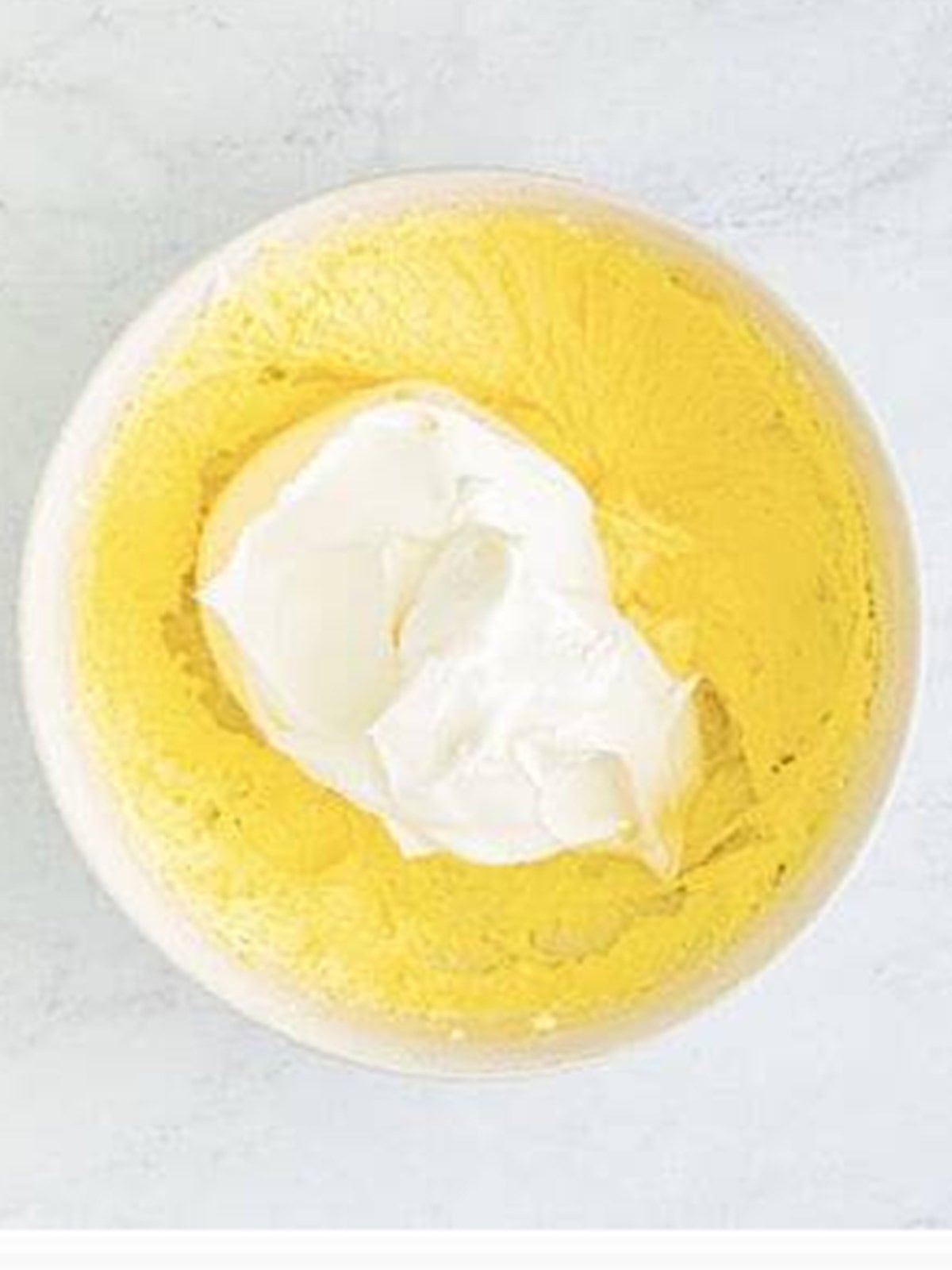 Whipped topping added to the bowl of cream cheese pineapple dip.