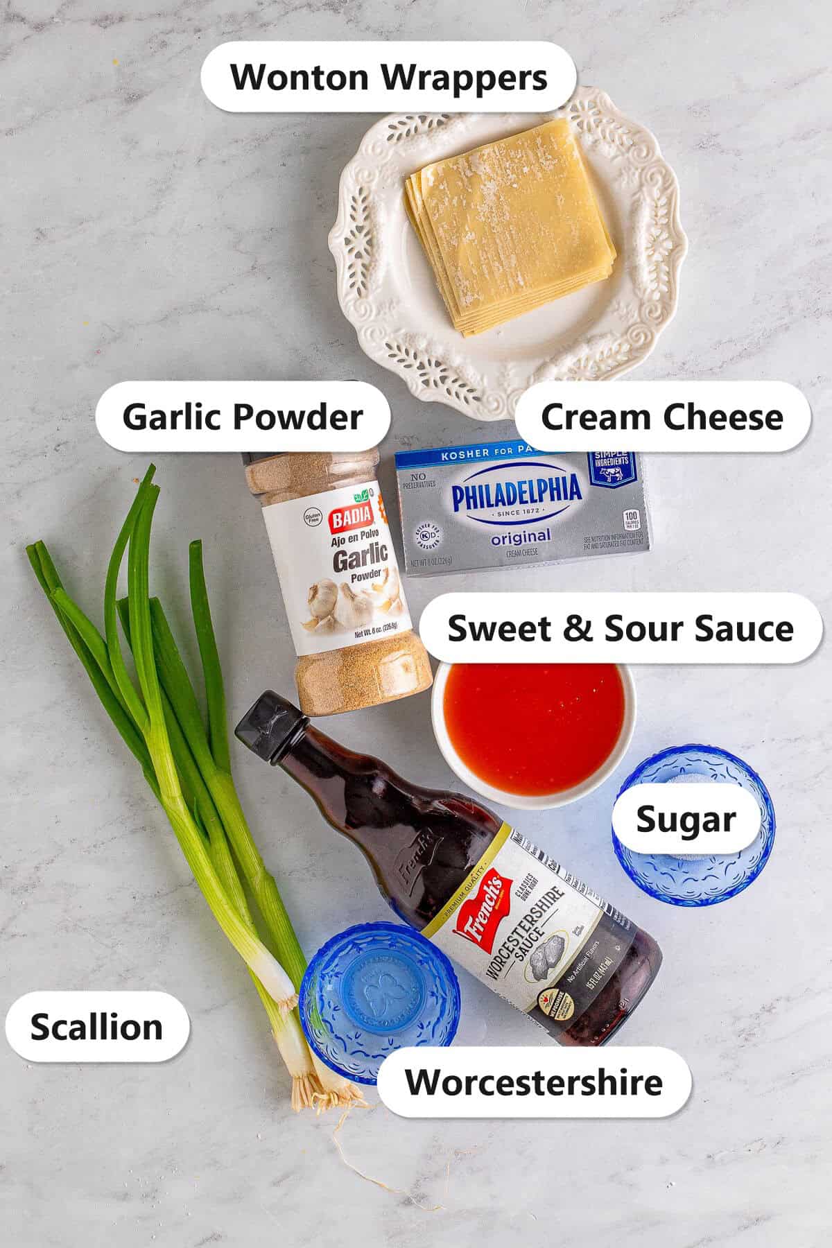 Labeled ingredients to make fried cream cheese wontons including cream cheese, scallion, garlic powder, sugar, Worcestershire, wonton wrappers, and sweet and sour sauce.