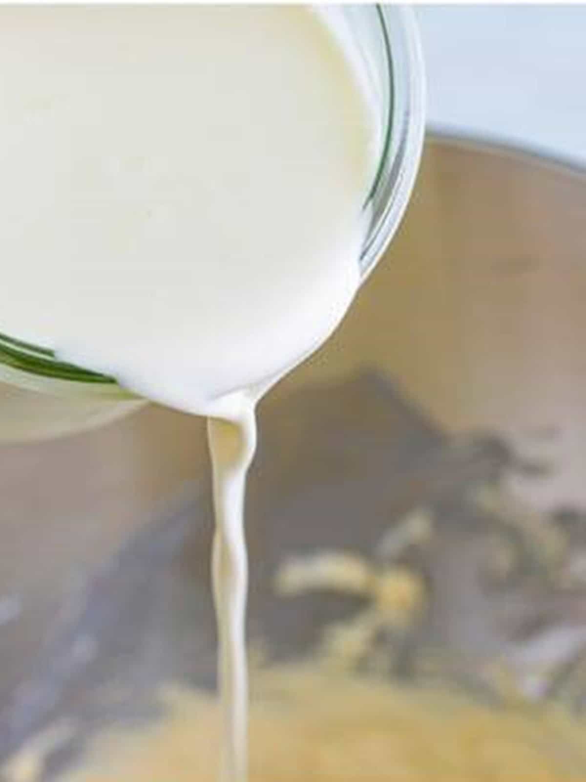 Streaming heavy cream into the cream horns filling in the stand mixer.
