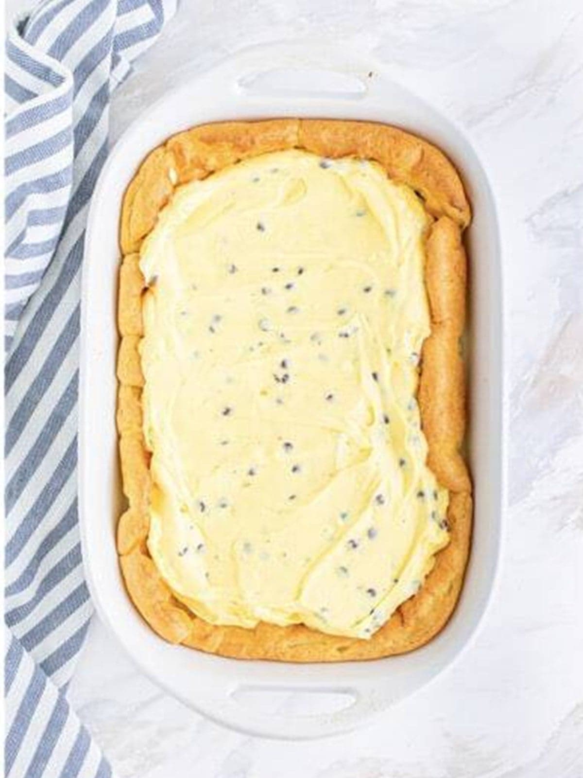 The cream filling spread evenly over the baked cream puff cake crust.