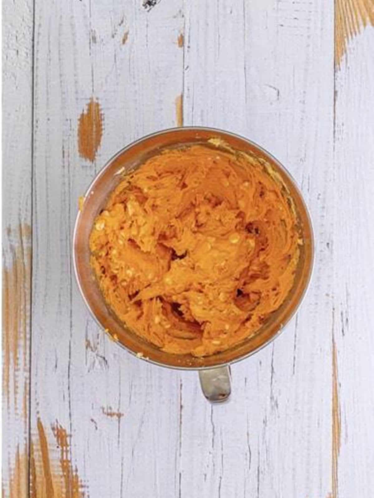 White chocolate chips stirred into orange creamsicle cookie dough.