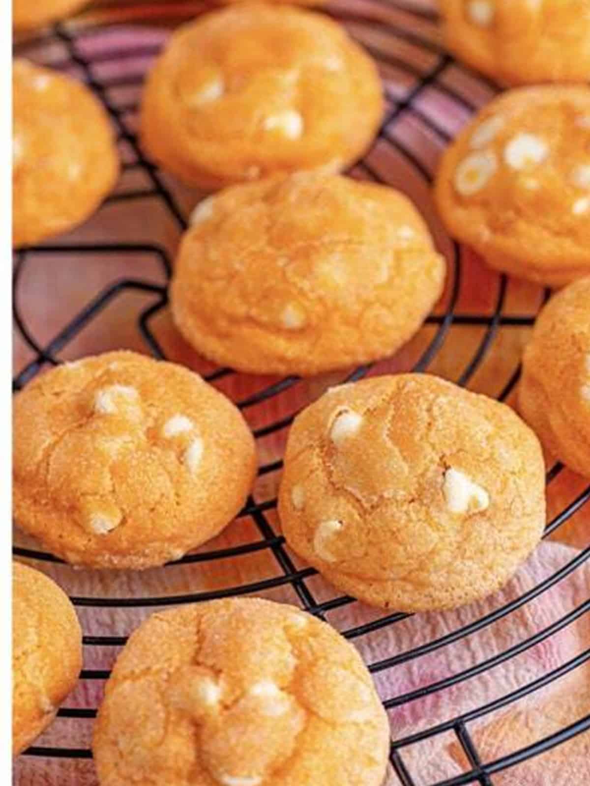 Baked orange creamsicle cookies cooling on a wire rack.