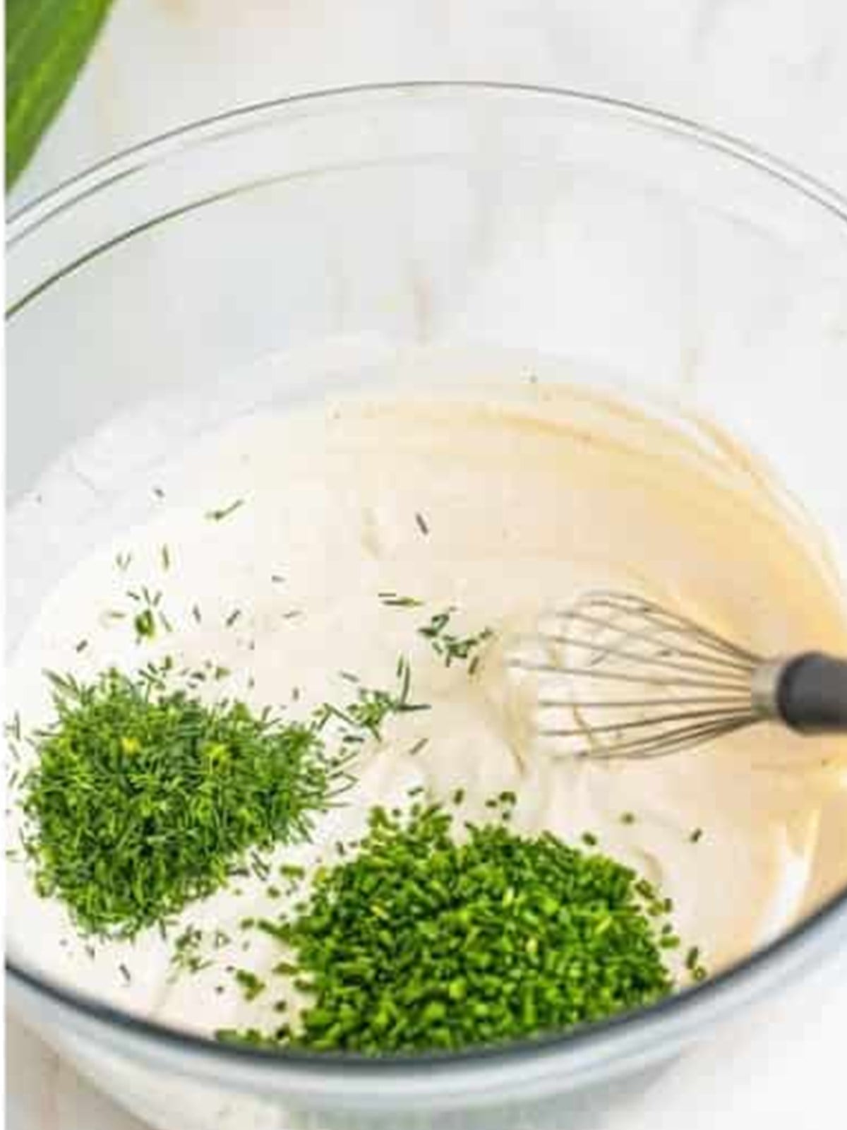 Fresh dill and chives added to the creamy sour cream dressing for cucumber salad.