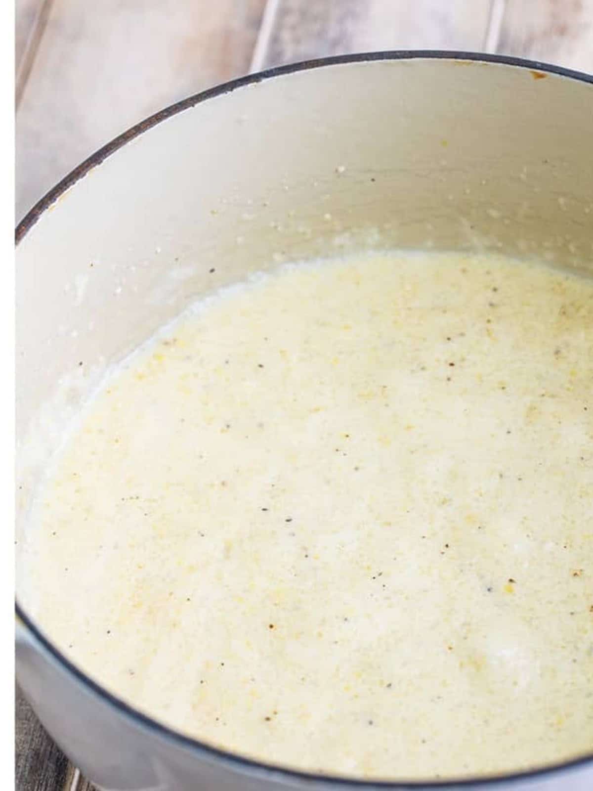 Creamy grits simmering in a pot until thick and smooth.