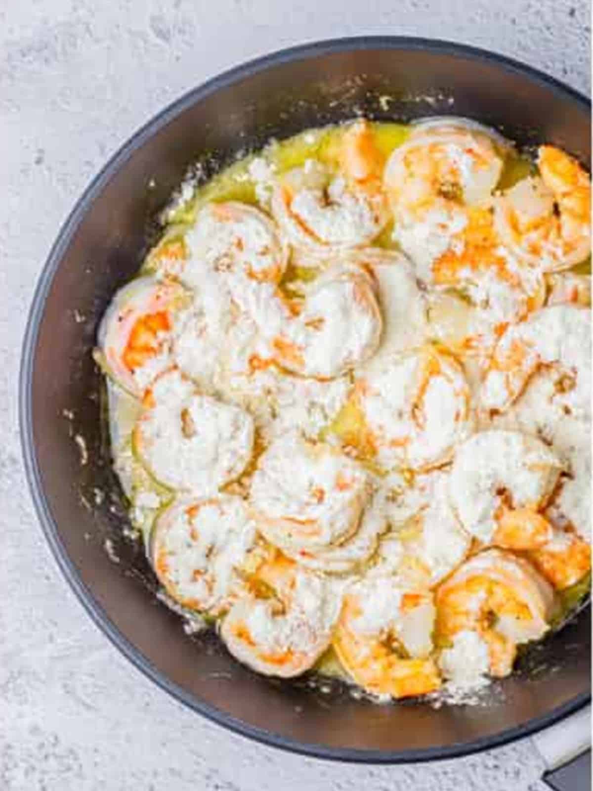 Flour stirred over the shrimp to coat for creamy lemon shrimp sauce.