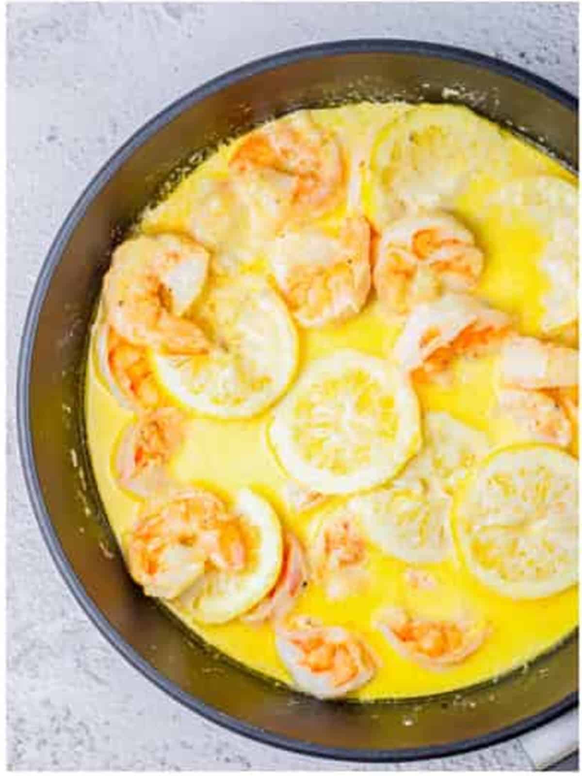 Half and half poured into the skillet to make the creamy lemon sauce.