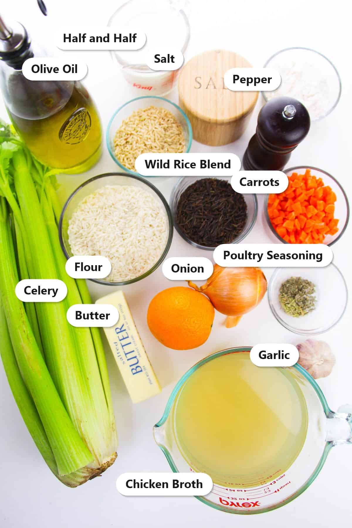 Labeled ingredients for creamy wild rice soup including wild rice blend, carrots, celery, onion, butter, flour, half and half, and chicken broth.