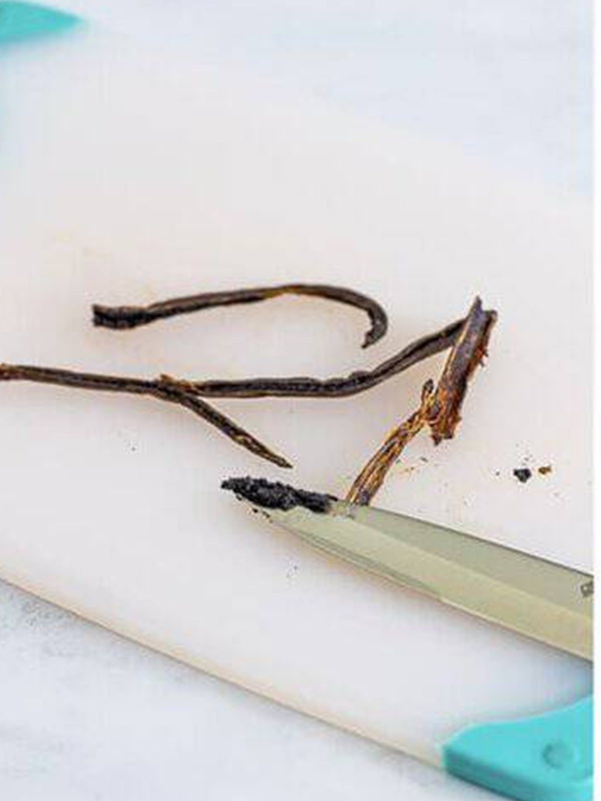 Splitting a vanilla bean and scraping out the seeds for creme anglaise.