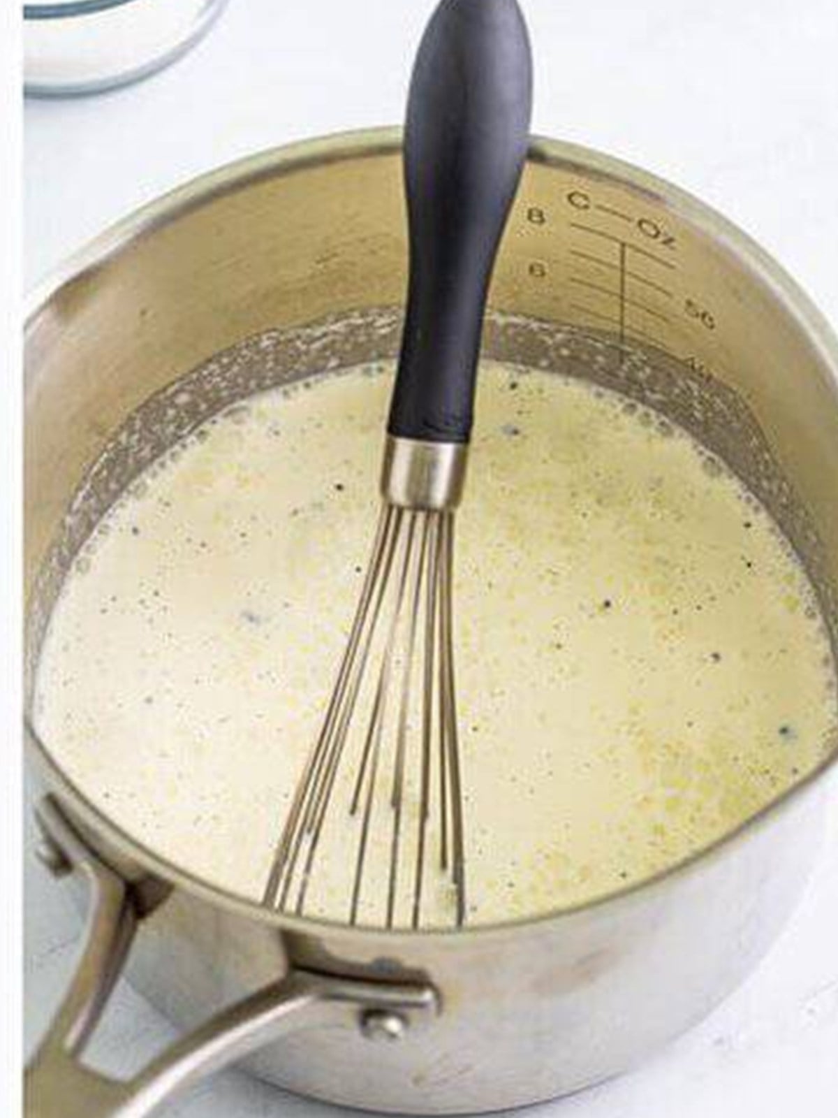 Heavy cream and milk simmering with vanilla bean in a saucepan for creme anglaise.