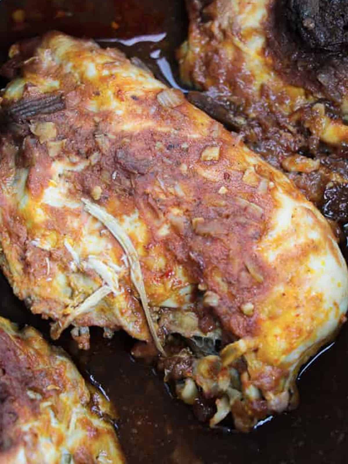 Cooked chipotle chicken in a crockpot ready to shred.