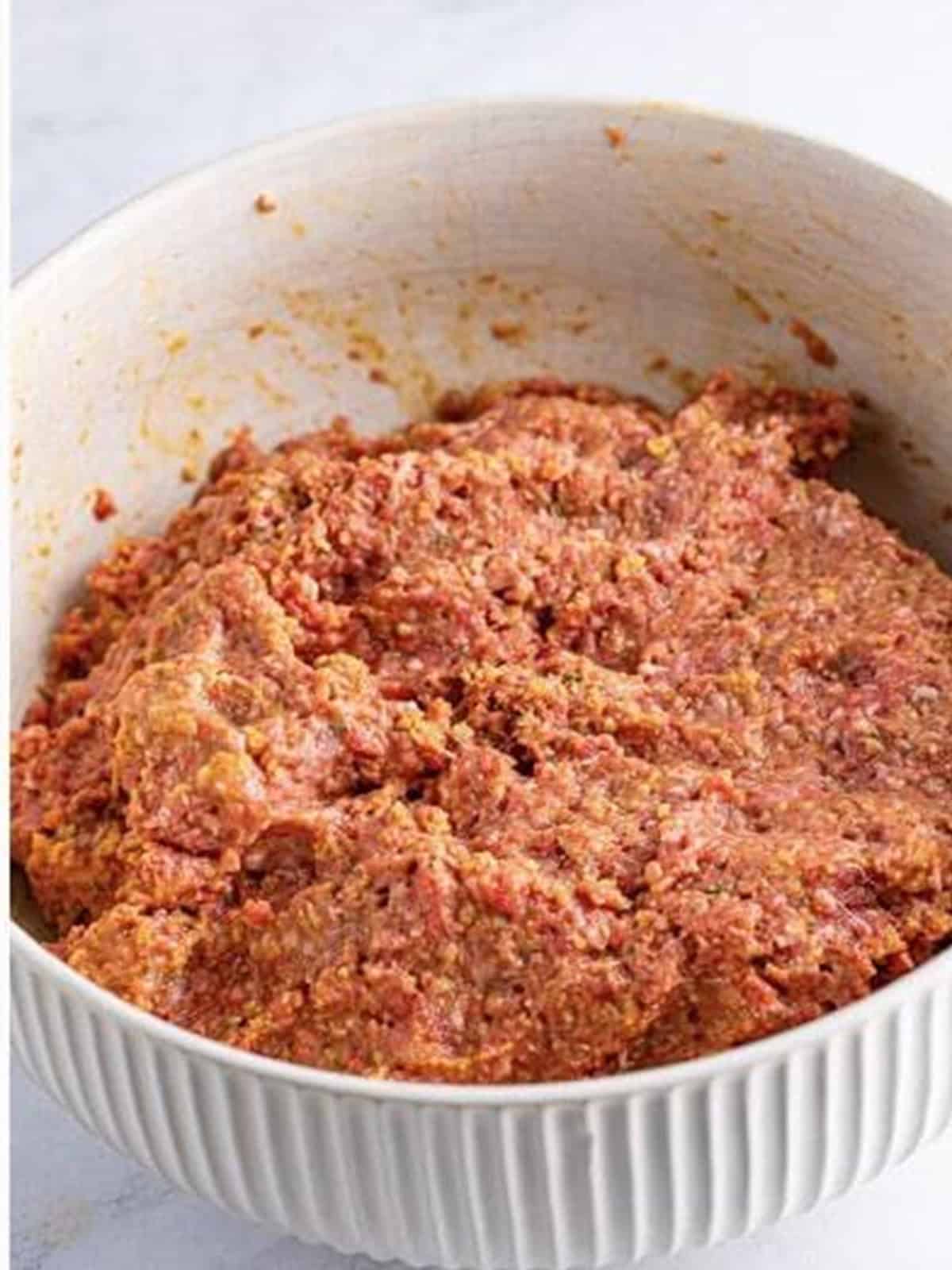 Meatloaf mixture combined by hand until just mixed for crockpot meatloaf.