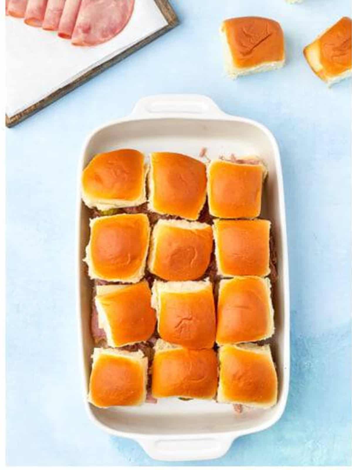 Roll tops placed on the layered Cuban sliders.