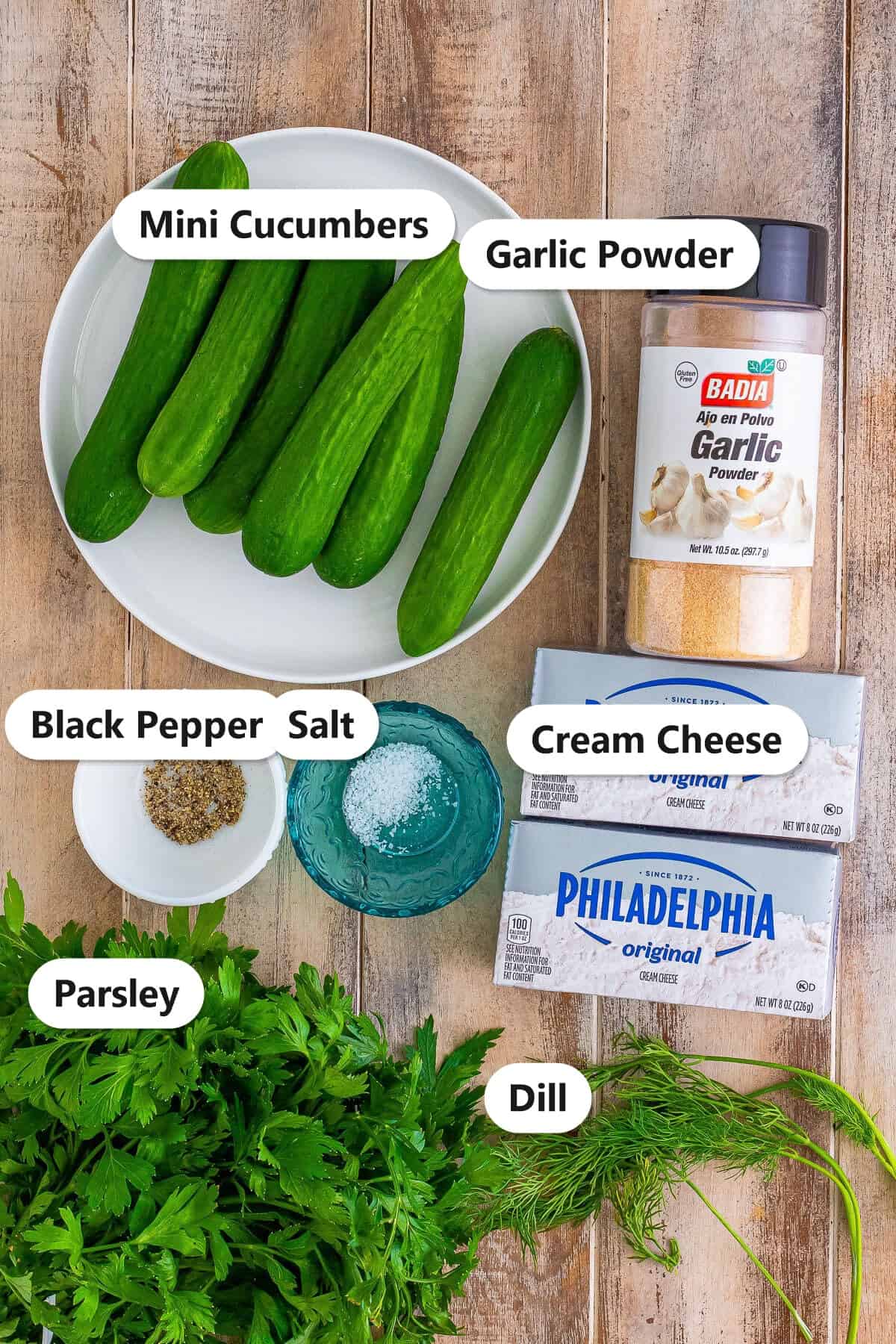 Labeled cucumber boats ingredients including mini cucumbers, cream cheese, fresh dill, parsley, garlic powder, salt, and black pepper.