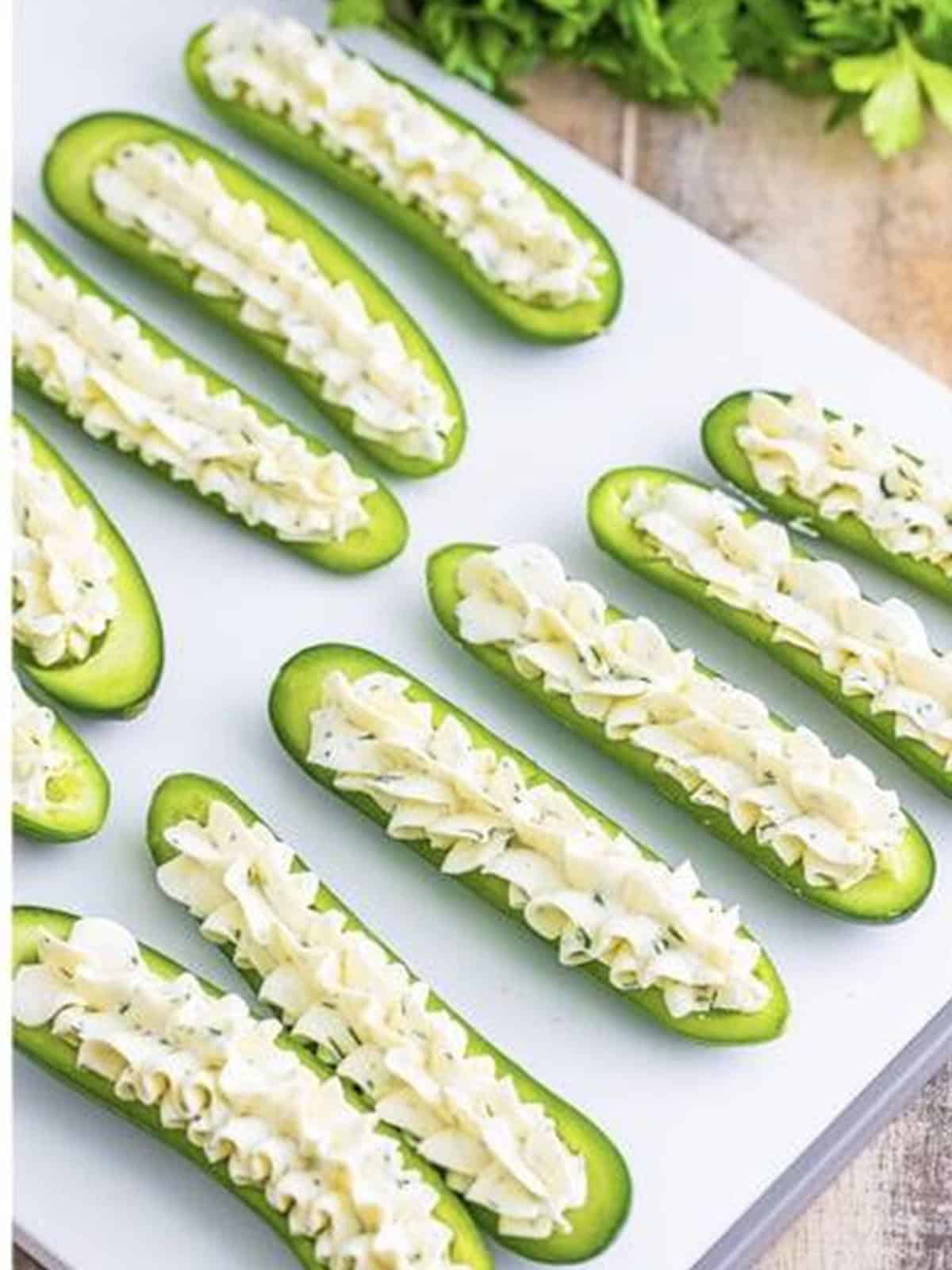 Cream cheese filling piped into the cucumber boats.