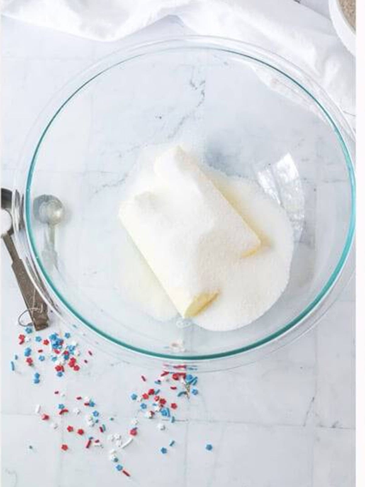 Butter and sugar in a glass bowl ready to be creamed together.