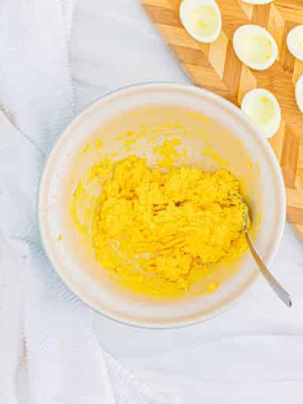 Mashed egg yolks mixed with mayonnaise and seasonings into a smooth deviled egg filling.
