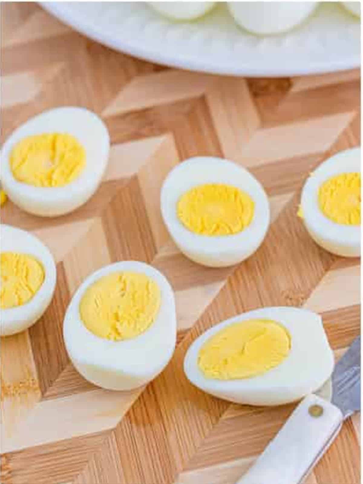 Peeled hard boiled eggs cut in half with the yolks removed.