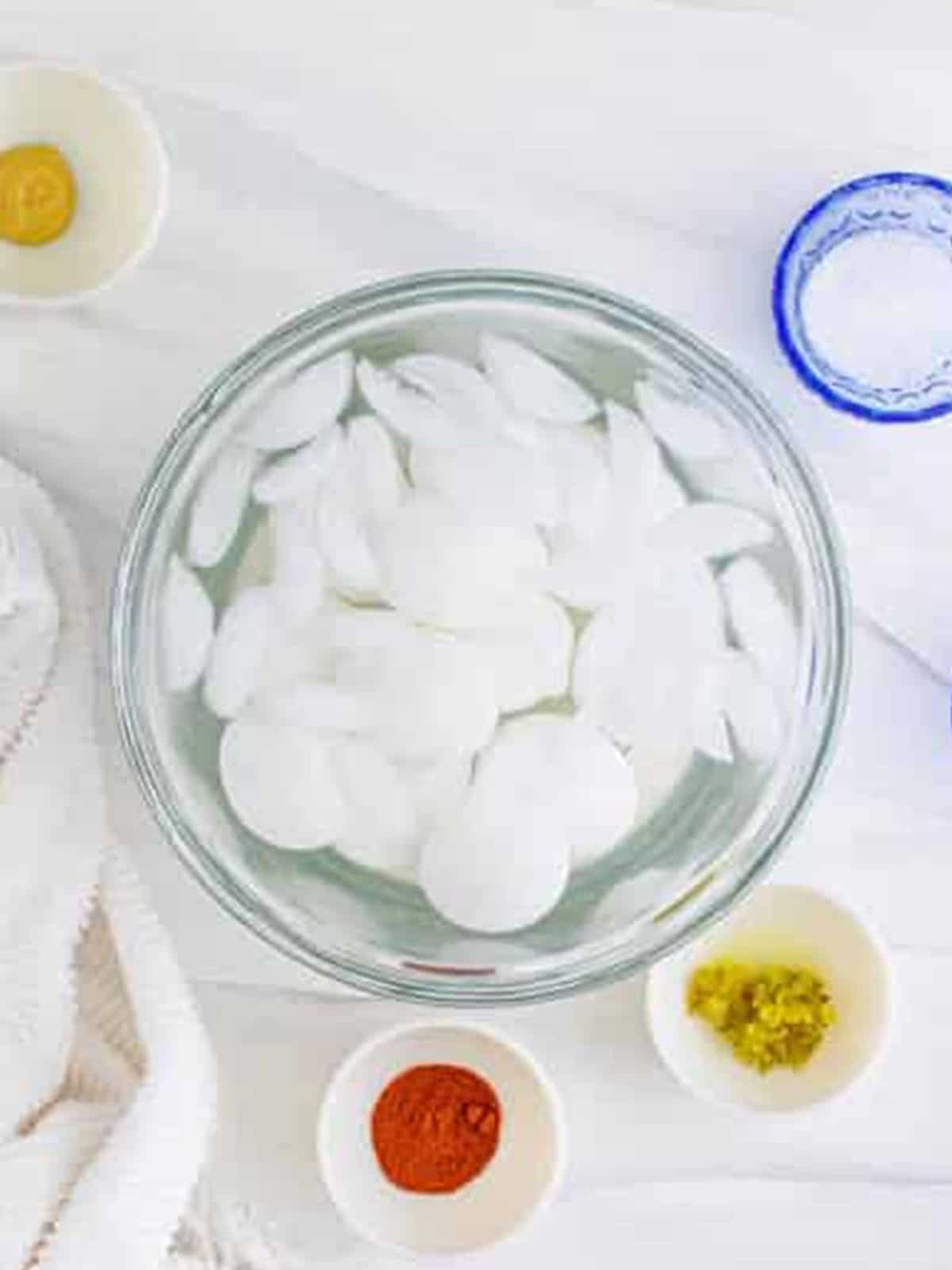 Hard boiled eggs cooling in an ice water bath.