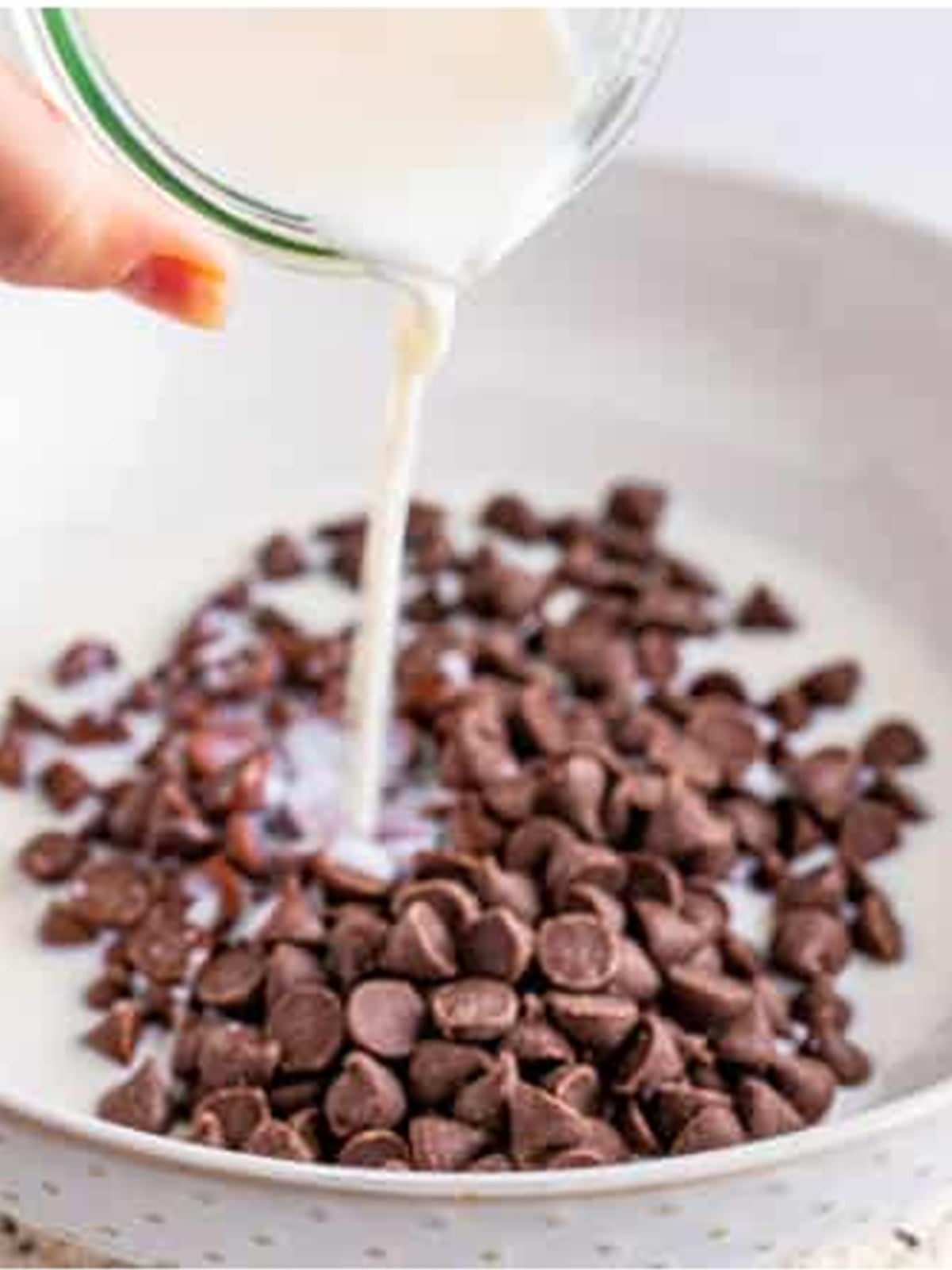 Hot milk poured over chocolate chips to make the chocolate mixture for ding dong cake.