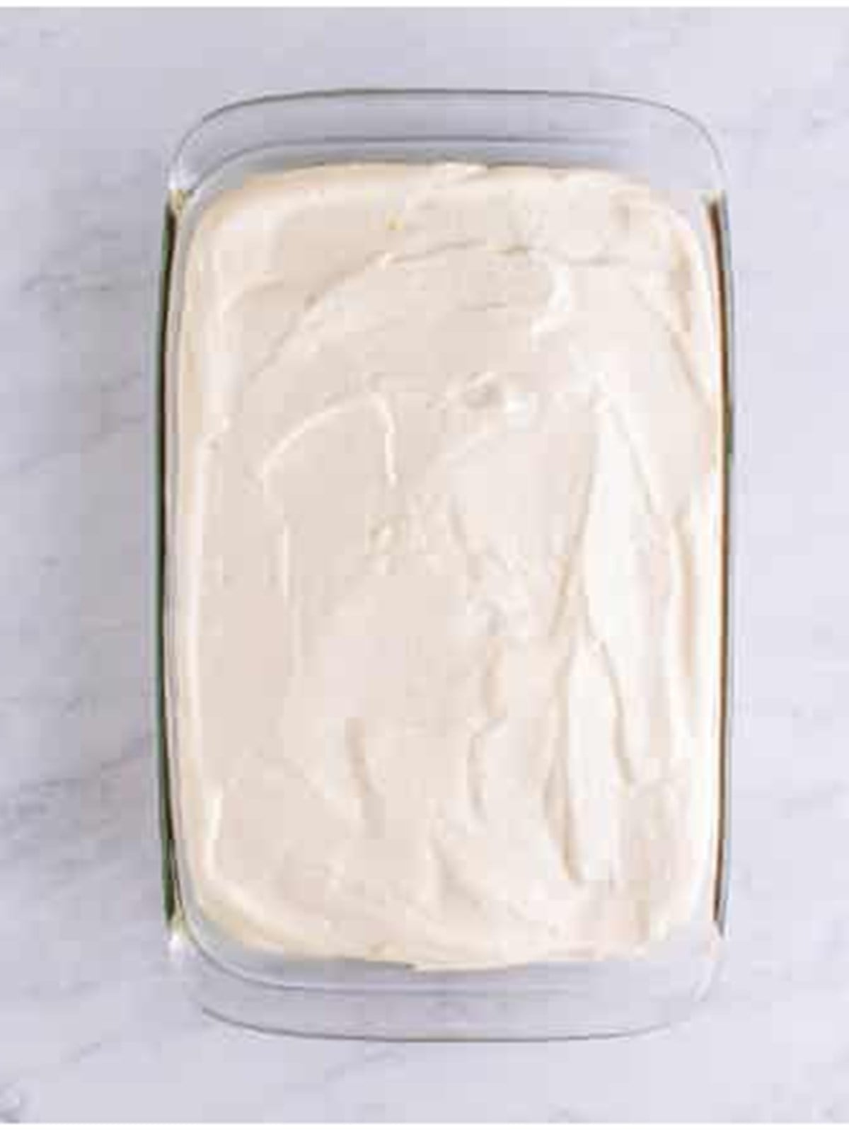 Whipped cream filling spread over the cooled chocolate cake.