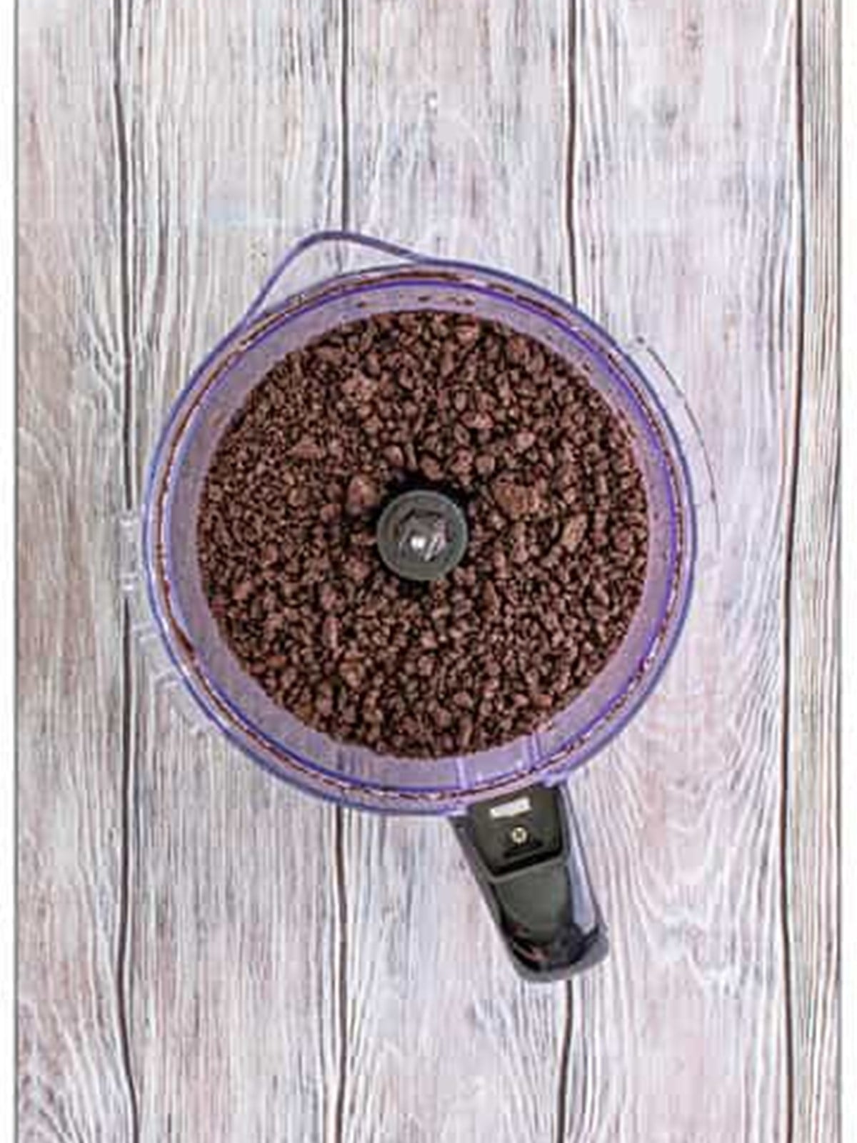 Oreos crushed into crumbs in a food processor for dirt cups.