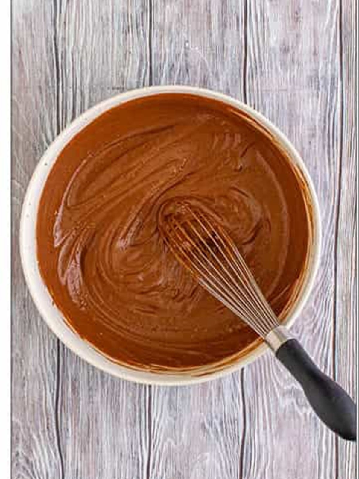 Chocolate pudding whisked smooth in a bowl.