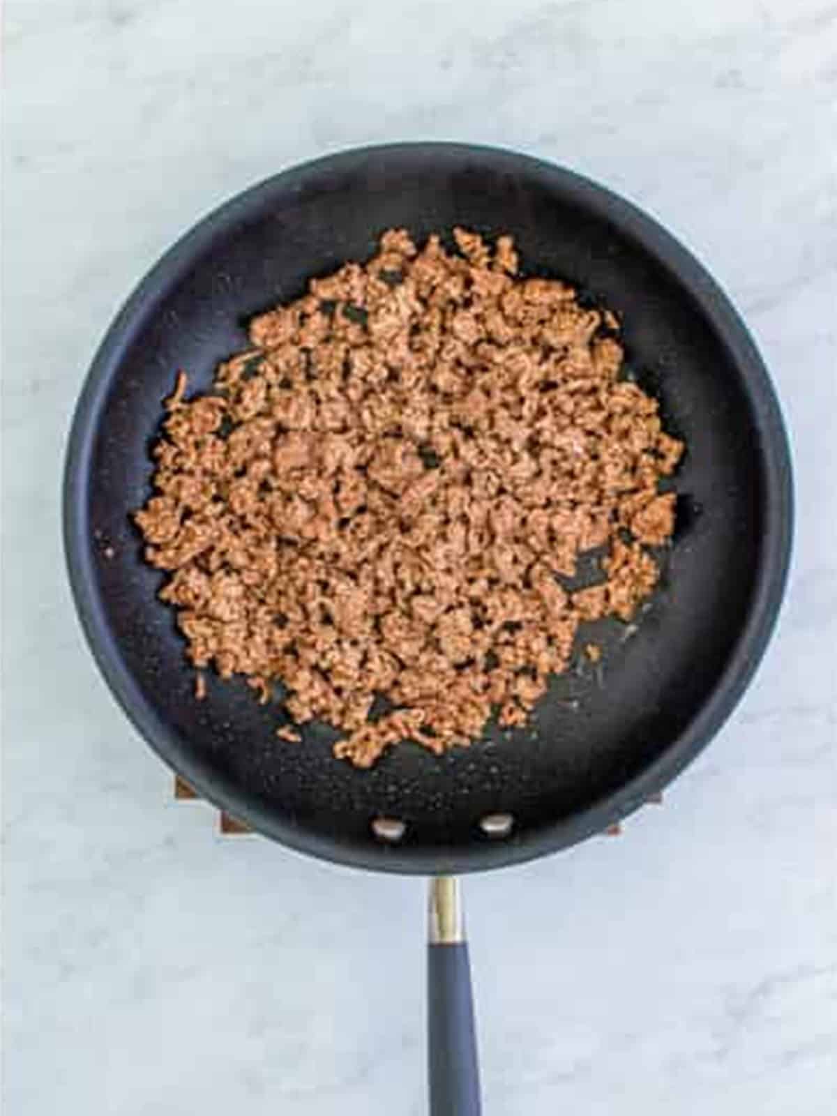 Browning ground beef in a skillet for Doritos Taco Salad.