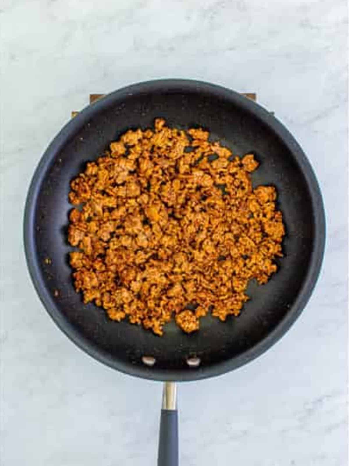 Stirring the seasoning into the ground beef for Doritos Taco Salad.