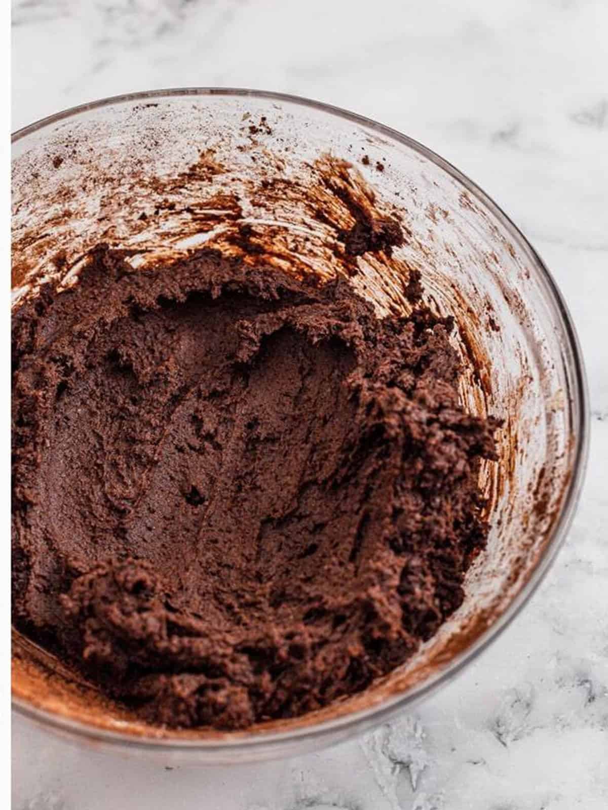 Cocoa powder and dry ingredients beaten into the dough to make double chocolate chip cookies.