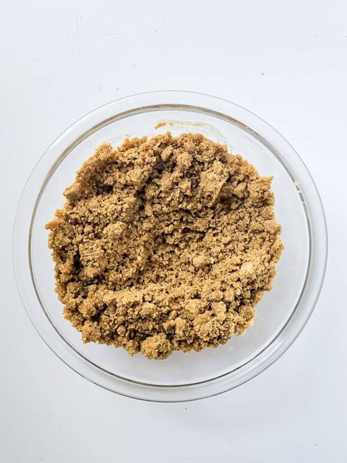 Graham cracker crumbs mixed with melted butter and cinnamon for the cheesecake crust.