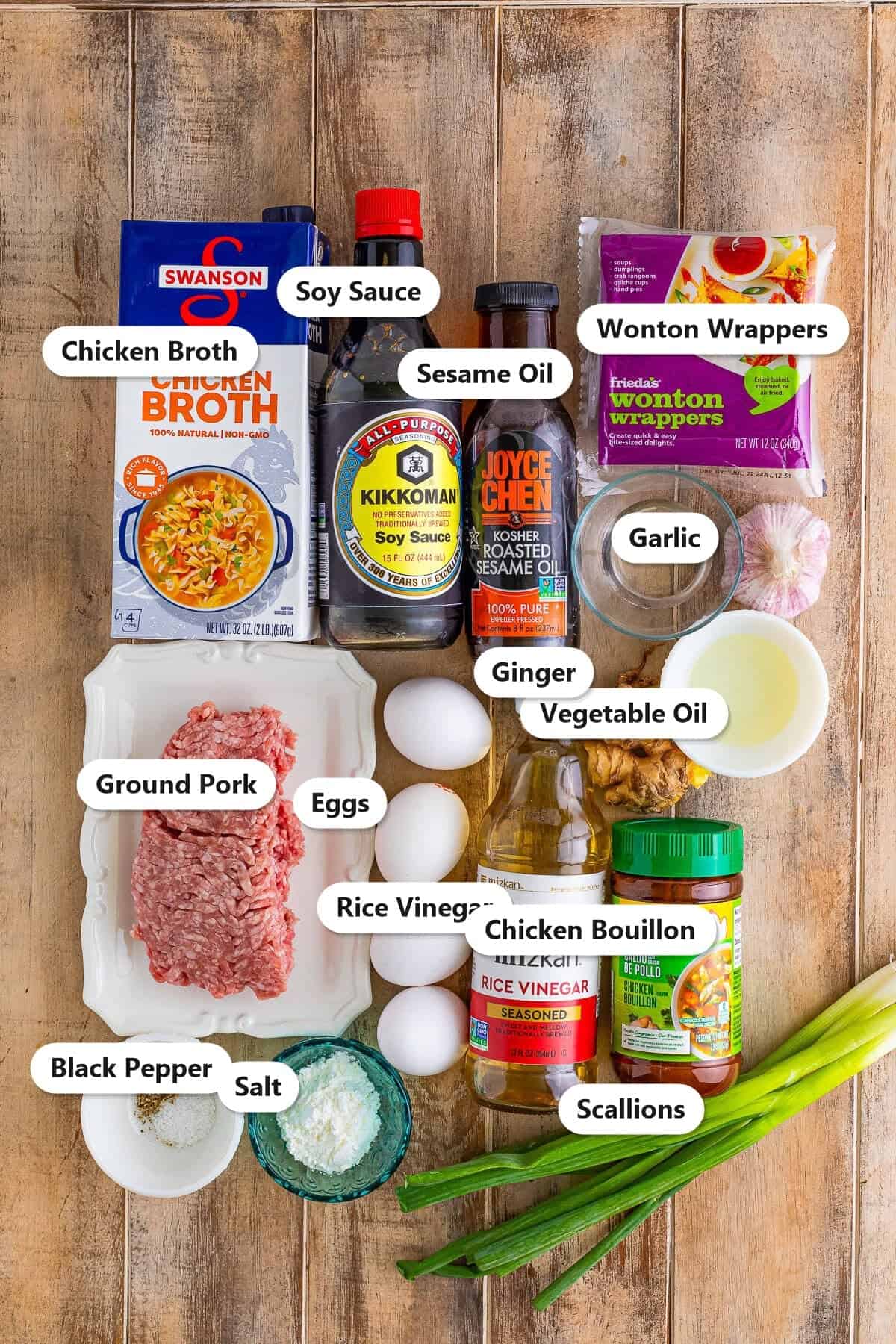 Labeled ingredients for wonton egg drop soup including ground pork, wonton wrappers, eggs, chicken broth, and seasonings.