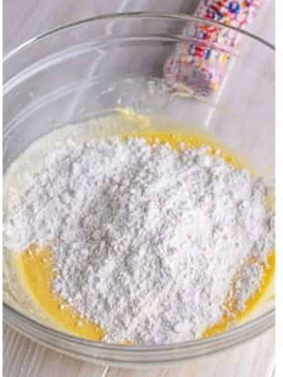 Folding self-rising flour into the fairy cake batter.